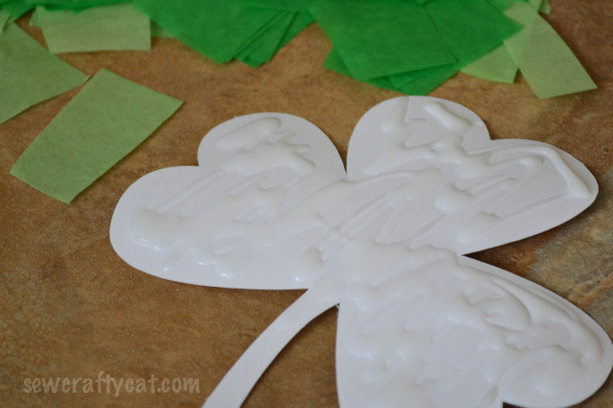 Spread glue on shape for tissue paper