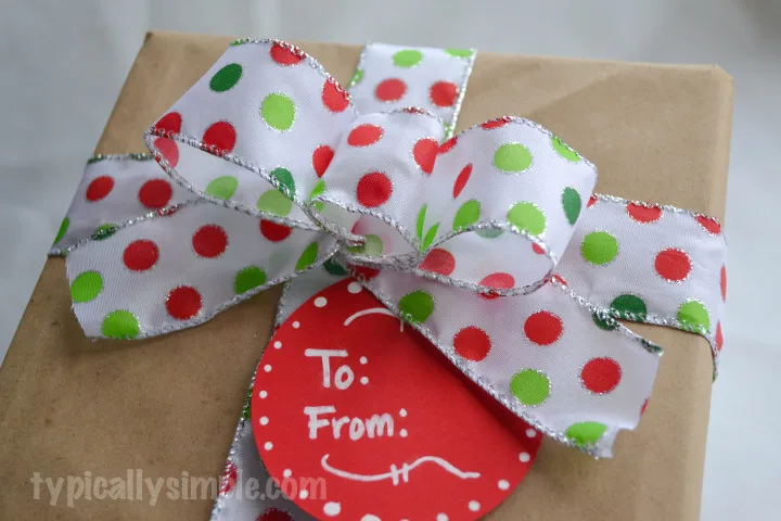 Curly, glittery green ribbon for gift wrapping on a white