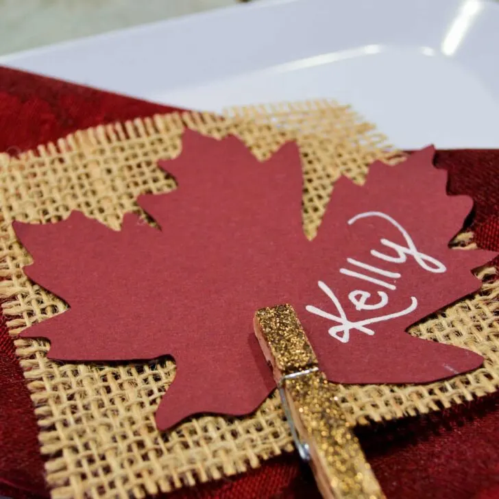 A simple place card for Thanksgiving dinner using burlap and glittered clothespins.