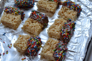 Dipping Rice Krispies treats into melted chocolate is a fun twist on a classic childhood treat we all know so well. A simple recipe to make with the kids!