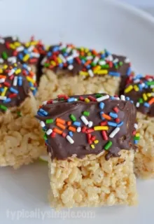 Dipping Rice Krispies treats into melted chocolate is a fun twist on a classic childhood treat we all know so well. A simple recipe to make with the kids!