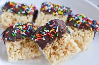 Dipping Rice Krispies treats into melted chocolate is a fun twist on a classic childhood treat we all know so well. A simple recipe to make with the kids!