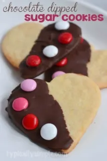 Simple sugar cookies dipped in chocolate and decorated with M&M's - a fun baking project to do with the kids!