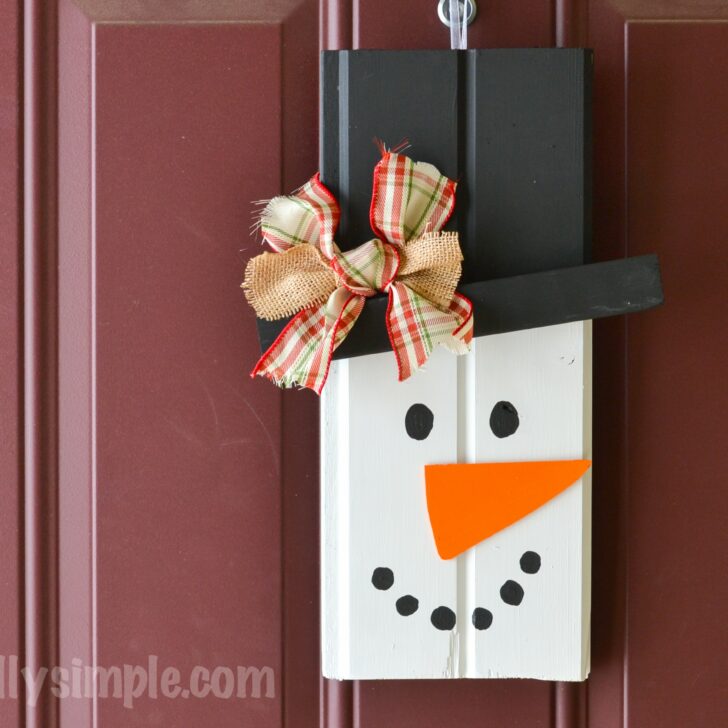 With two pieces of scrap wood, some paint, and a few other supplies from your craft stash, create this cute rustic snowman to hang on your front door!