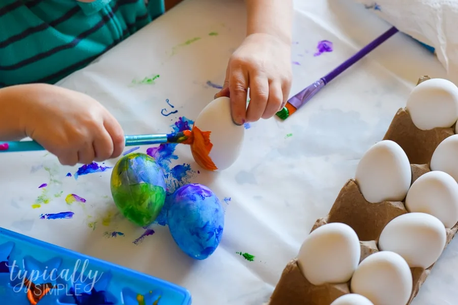 A fun alternative to using dye, grab some paint supplies to make these bright and colorful Easter eggs with the kids!