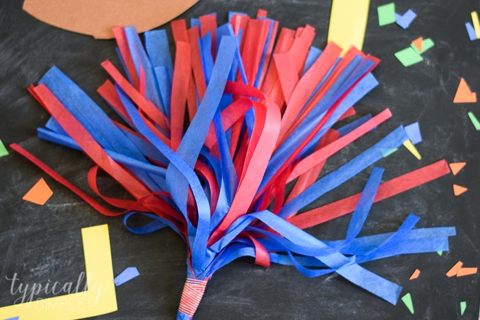 red and blue tissue paper pom poms for kids to cheer with at football games