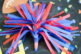 red and blue tissue paper pom poms for kids to cheer with at football games